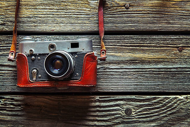 istock Retro camera on wood table background, vintage color tone 625189244