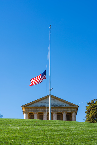 Arlington National Cemetery JFK Memorial American Flag White Cross Green Hill Blue Sky