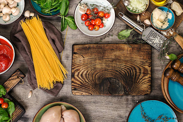 istock Kitchen board with raw spaghetti and ingredients for cooking pas 625192312