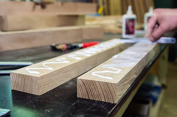 Spreading the adhesive on bonding surfaces. Joinery stock photo