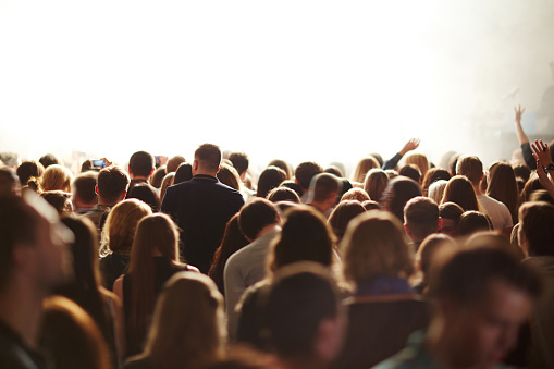 Heads of crowd of fans during concert of popular singer