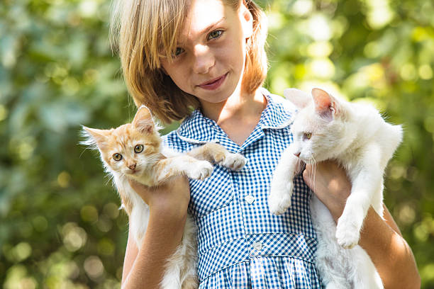 istock Girl play with kitten 625193770