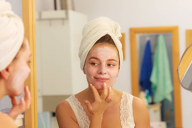 istock Woman applying mask cream on face in bathroom 625202278