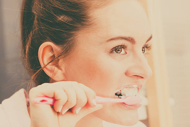 istock Woman brushing cleaning teeth in bathroom 625205470