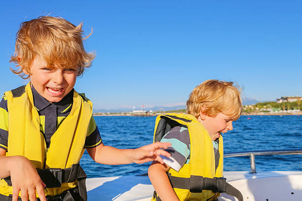 istock two little kid boys enjoying sailing boat trip 625205780