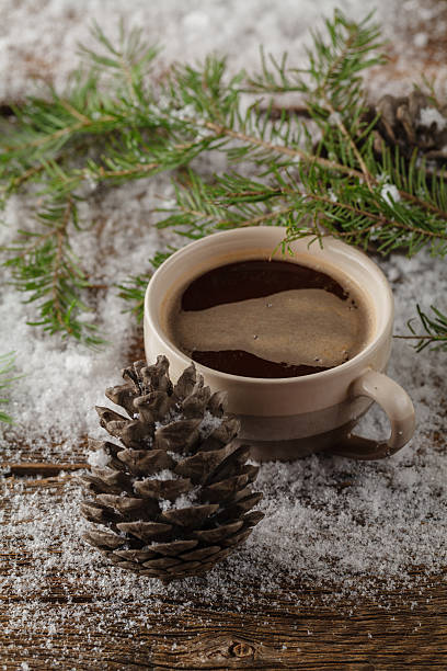 istock mug of tea and green xmas tree on snow on 625205814