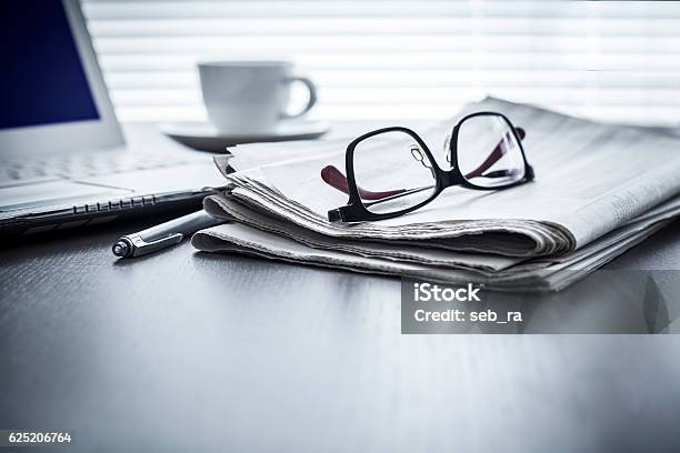 Newspaper With Computer On Table Stock Photo - Download Image Now - Newspaper, The Media, Eyeglasses