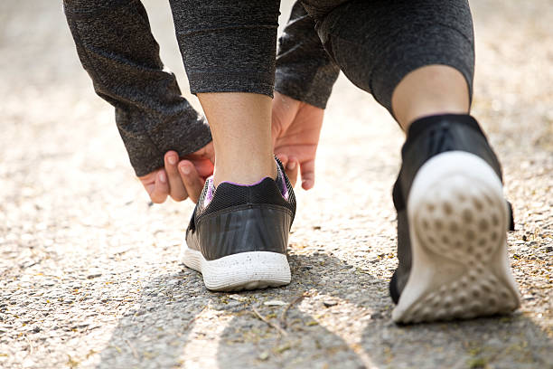 istock Female runner tying her shoes 625207074