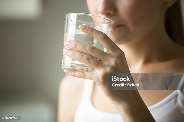 Female Drinking From A Glass Of Water Stock Photo - Download Image Now - Drinking Water, Drinking, Drink
