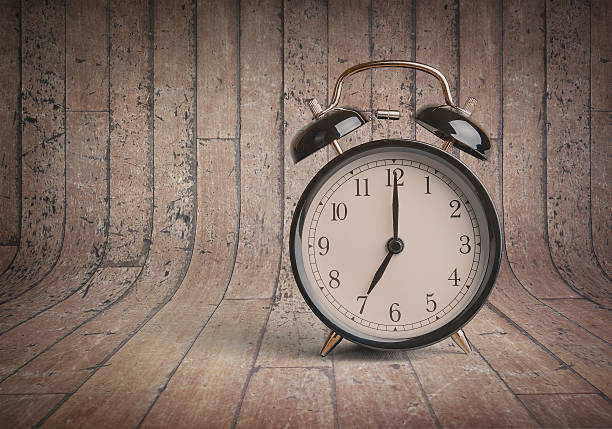 istock it's seven o'clock already, vintage old black metallic alarm clock 625209806