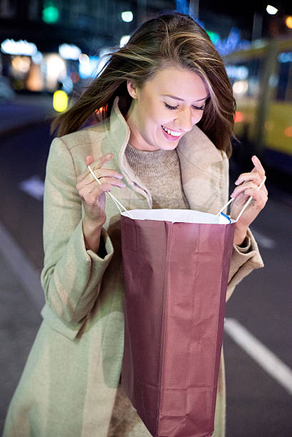 istock Beautiful young woman looking at a gift bag 625217804