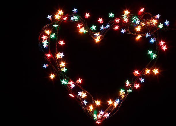 istock Heart from christmas lights on black background 625219842