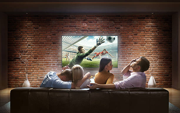 istock Two couples watching Soccer game at home 625222526