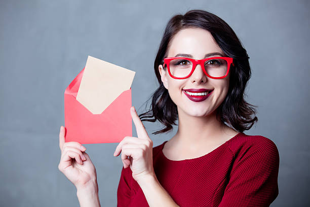 istock woman in black dress with envelope 625229480