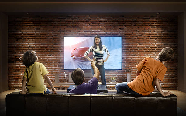 istock Family with children watching Bobsleigh competition on TV 625229594