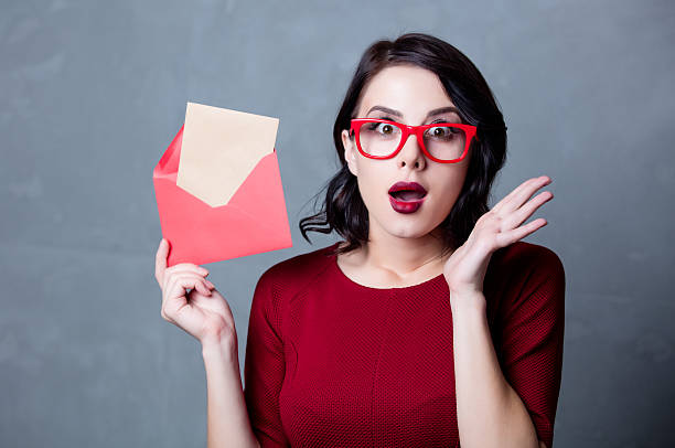 istock woman in black dress with envelope 625229726