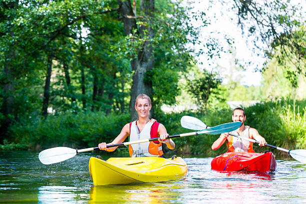 istock Friends paddling with canoe on forest river 625230688