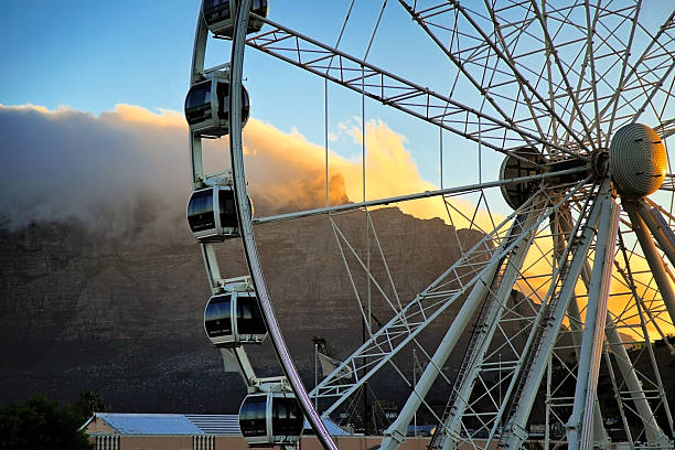 Cape Town, South Africa Waterfront observation Wheel close-up during summer sunset. At the background there is a part of Table Mountain.