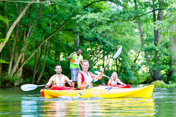 istock Friends paddling with canoe on forest river 625230920