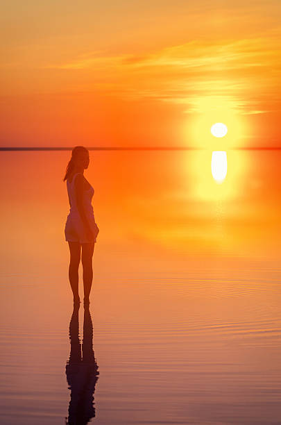 istock Beautiful female model open arms under sunrise at seaside. Calm 625231616