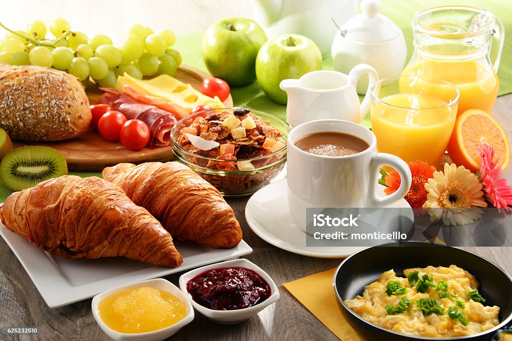 Breakfast served with coffee, juice, egg, and rolls Breakfast served with coffee, orange juice, egg, rolls and honey. Balanced diet. Breakfast Stock Photo