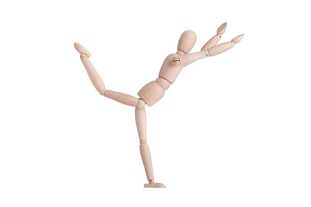 Happy wooden mannequin one leg standing