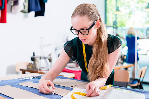 istock Tailor transfers pattern of fashion design to cloth 625236768