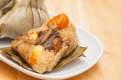 Zongzi is a traditional Chinese food, made of glutinous rice stuffed with different fillings and wrapped in bamboo, reed, or other large flat leaves.