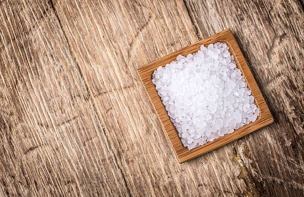 istock sea salt in wooden bowl 625241670