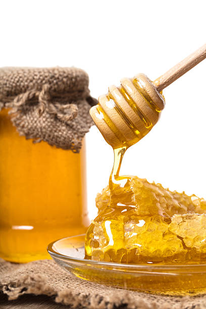 istock Honey dripping from wooden spoon 625242246