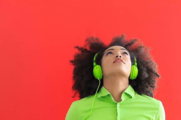 istock Young woman with green headset looking up 625242770