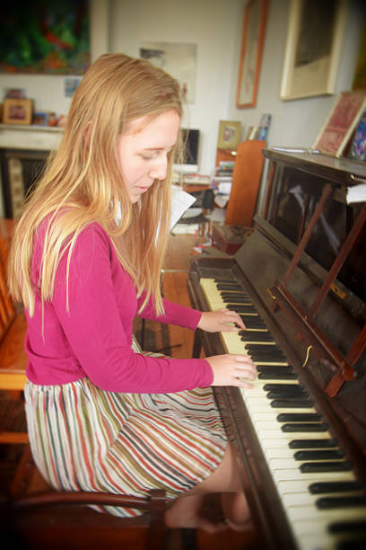 istock Young lady plays piano by ear 625243736