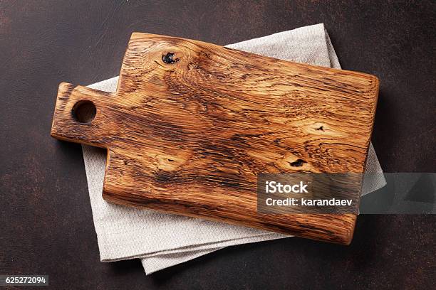 Cutting Board Over Towel On Stone Kitchen Table Stock Photo - Download Image Now - Cutting Board, High Angle View, Slate - Rock