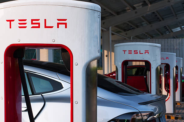 Tesla supercharger parking Shenzhen. China - November 15, 2016: Tesla model S cars charging their battery with the Tesla supercharger station near Shenzhen sport arena. Tesla is an American automotive and energy storage company that designs, manufactures and sells luxury electric cars shenzhen technology stock pictures, royalty-free photos & images