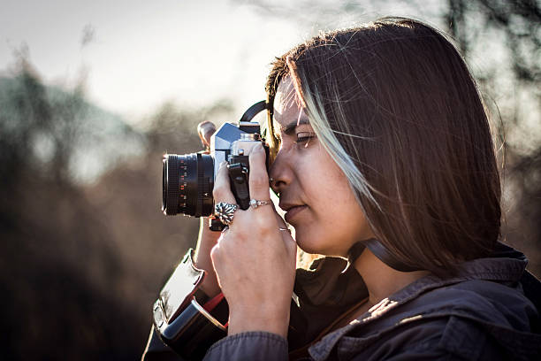 istock Brunette taking picture in the park in beatiful fall afternoon 625281638