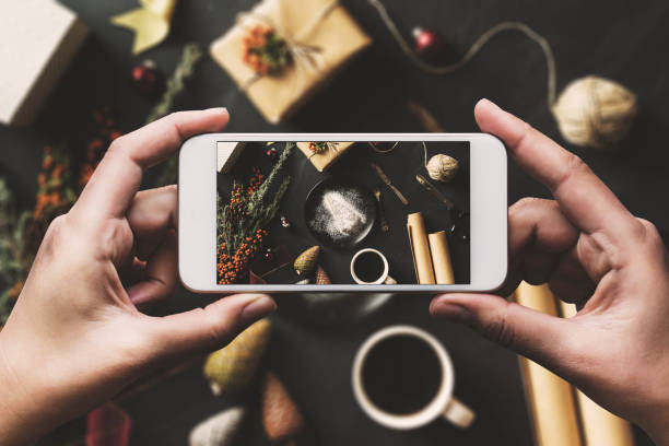 istock Hand using smartphone, sharing Christmas flat lay on social media 625282378