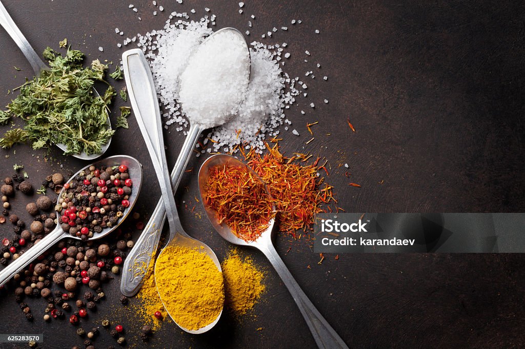 Various spices spoons on stone table Various spices spoons on stone table. Top view with copy space Spice Stock Photo