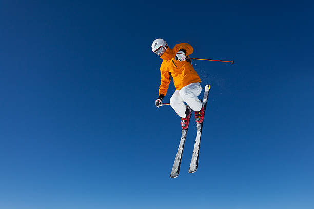 freestyle skier in air freestyle skier in the air over blue sky extreme skiing stock pictures, royalty-free photos & images