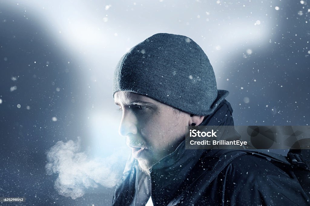 hiker breathe out in front of blurred mountain landscape Breath Vapor Stock Photo