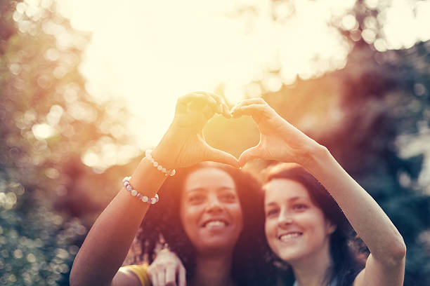 istock Mixed race girls showing heart symbol 625301844