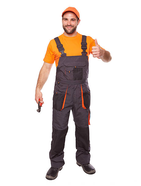 istock Smiling worker in blue uniform holding pliers 625304760