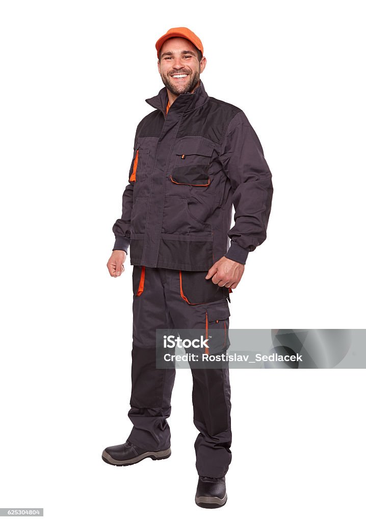 Smiling worker in uniform with orange cap Smiling worker in uniform with orange cap isolated on white background Cut Out Stock Photo