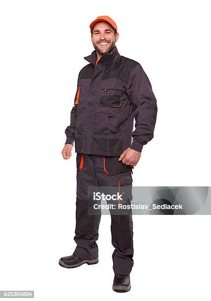 Smiling Worker In Uniform With Orange Cap Stock Photo - Download Image Now - Cut Out, Craftsperson, Blue-collar Worker