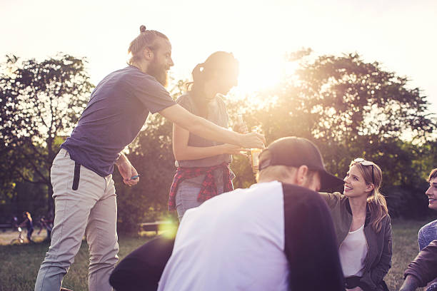 Group of friends on picnic in park having a good time