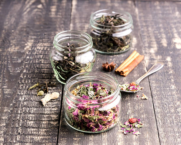istock Glass jar with dry tea Wooden background 625306000