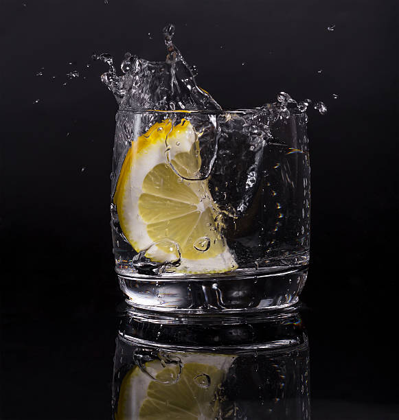 istock Falling in a glass of lemon, splash isolated 625307296