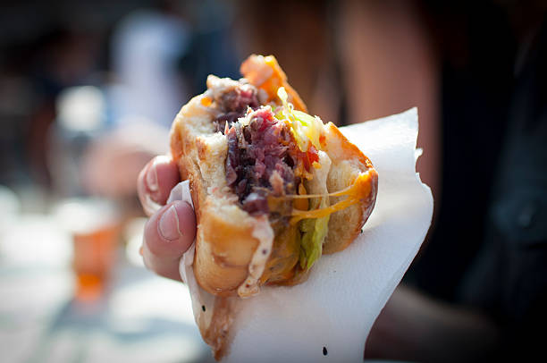 istock beef neck burger holding by hand 625307438
