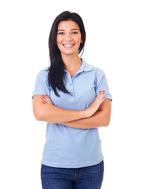 Woman in blue polo shirt with arms crossed Beautiful woman in blue polo shirt with arms crossed, on a white background polo shirt stock pictures, royalty-free photos & images