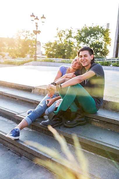 istock Young couple sitting and laughing on steps. 625312116