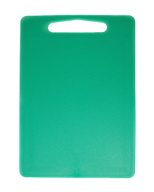 istock Unused plastic green cutting board isolated over the white background 625328334